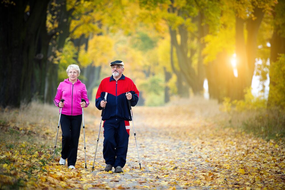 A senior couple walking during the fall months