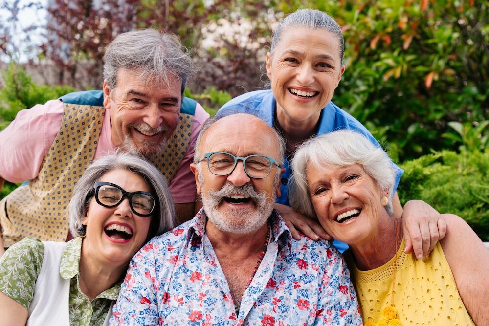 Group of senior friends outside enjoying the perks of Independent living oceanside