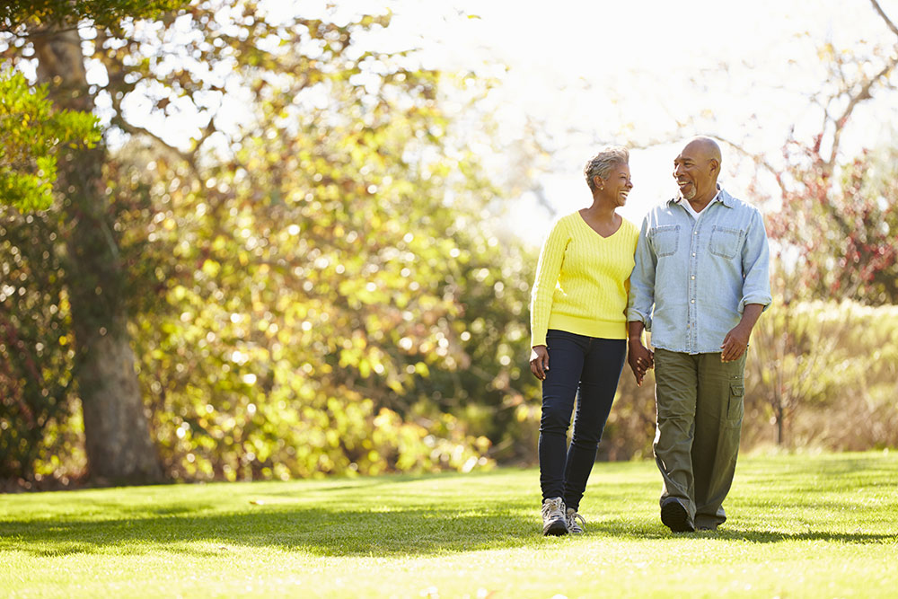 Happy senior couple walking on nice summer day outside