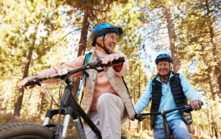 Happy senior couple riding bikes outside