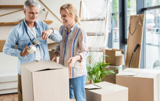 Senior couple packing to move