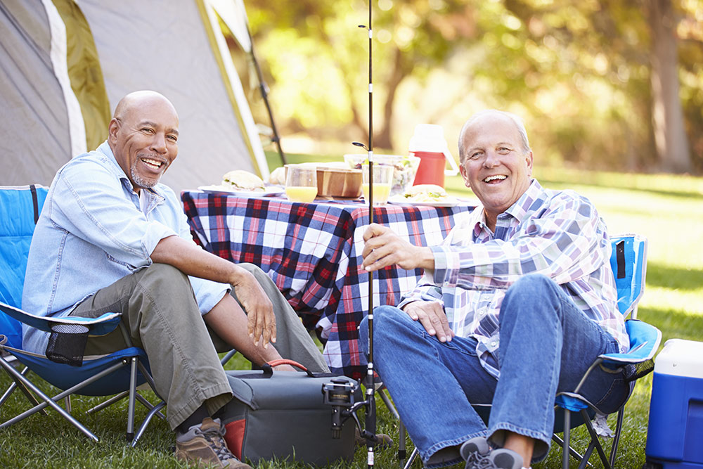 Two senior men happy on fishing trip at camp