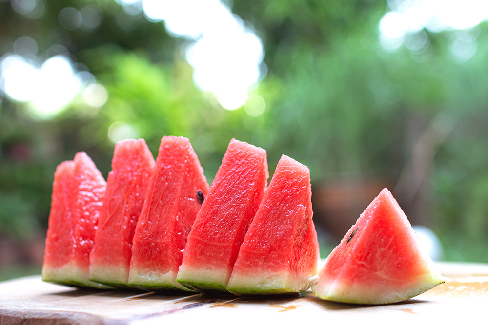 Sliced watermelon on table outside