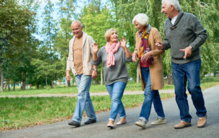 Four seniors enjoy a walk on a fall day