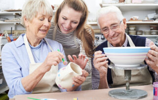 A senior couple takes a pottery class