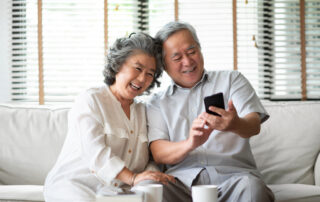 A senior couple using their smart phone