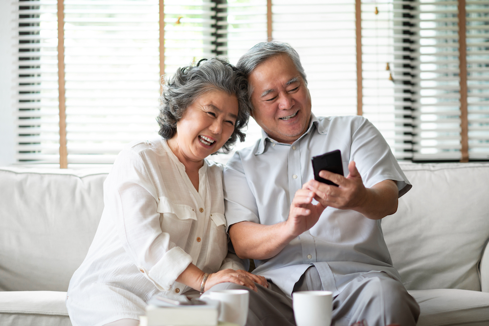 A senior couple using their smart phone