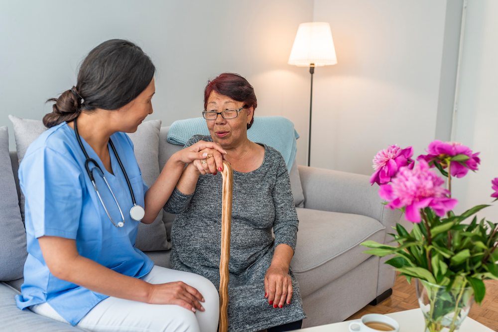 A nurse and a resident carry on a conversation