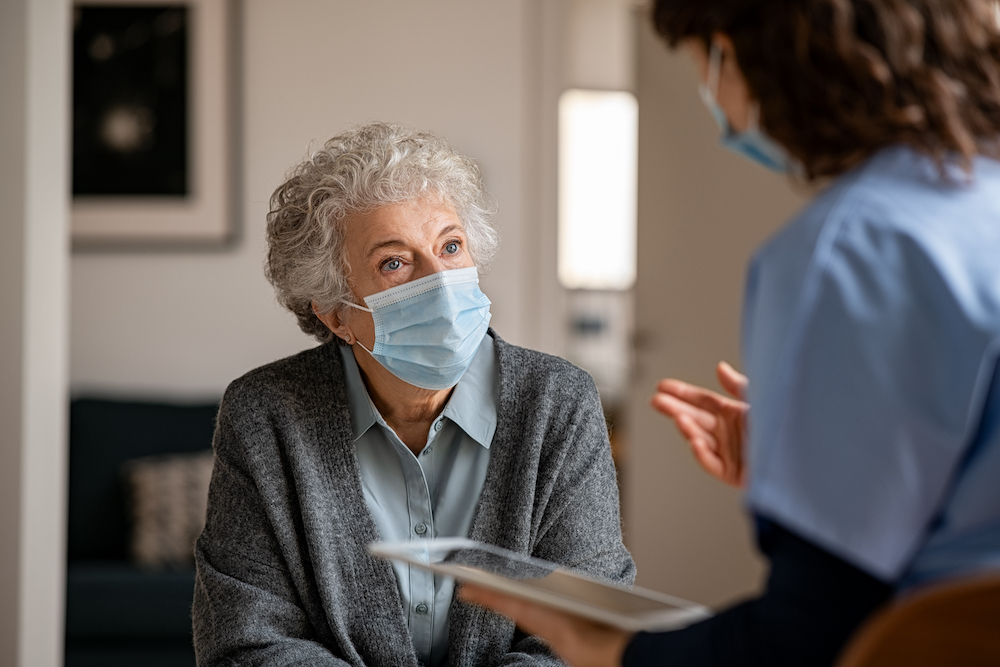 Senior woman talking about fish oil supplements with her doctor