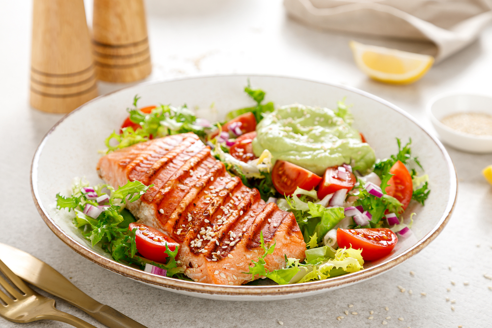 A salad bowl with grilled salmon filet