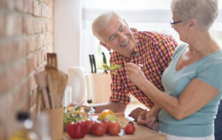 A senior couple preps a healthy meal together