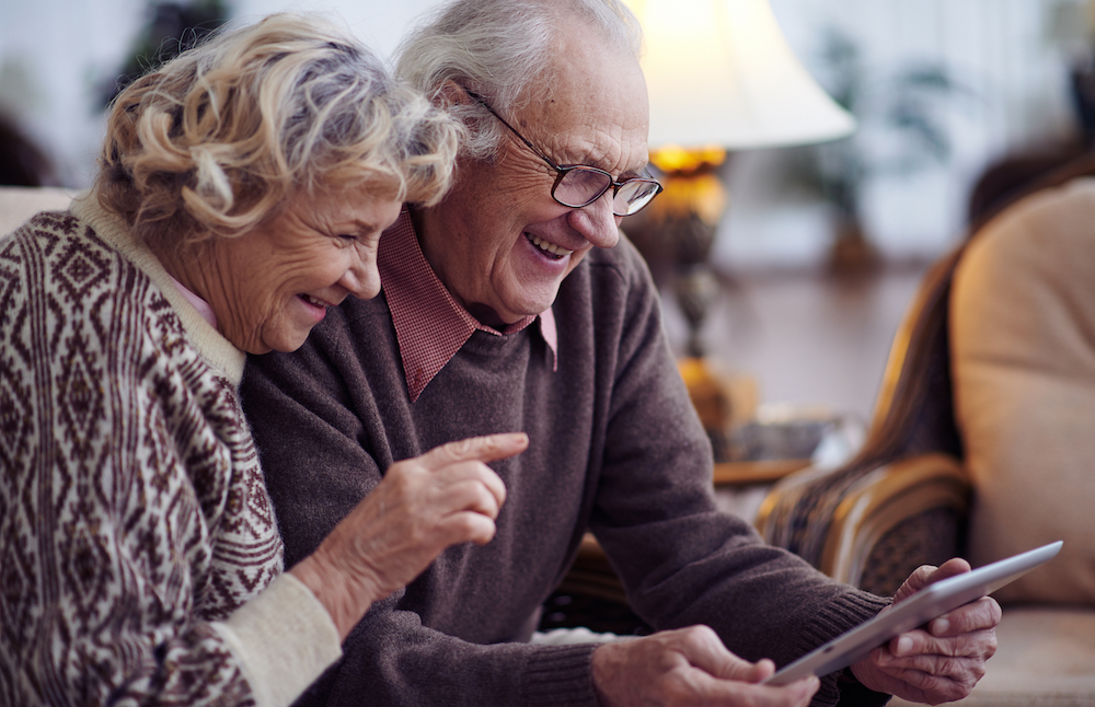 A senior couple uses technology to stay in touch with their family and friends