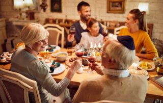 An older Jewish couple enjoying a traditional meal with family