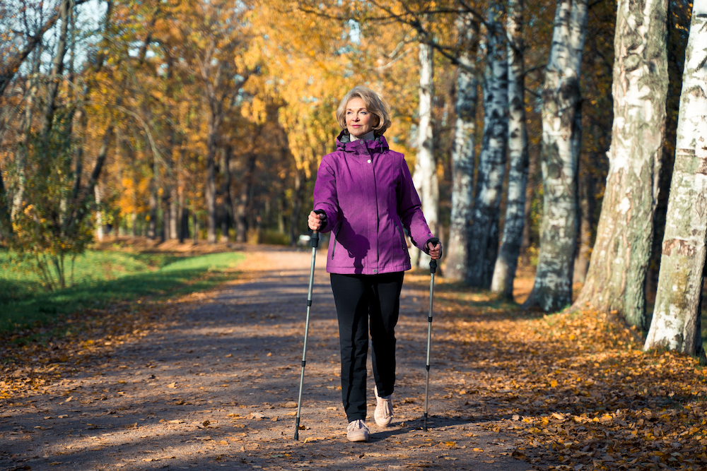 Carlsbad assisted living facilities resident goes for a fall walk outdoors.