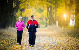 A senior couple walking during the fall months