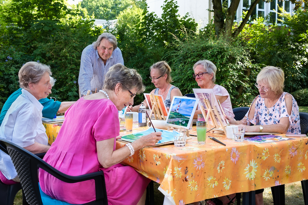 A group of senior friends taking an art class together