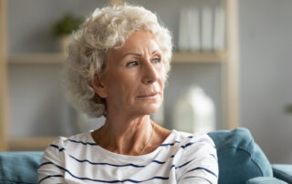 A close up image of a senior woman looking off into the distance