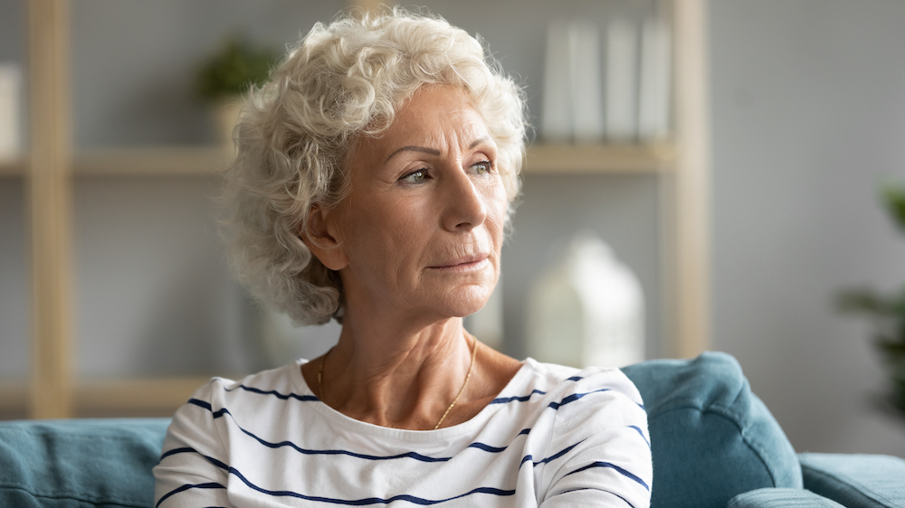 A close up image of a senior woman looking off into the distance