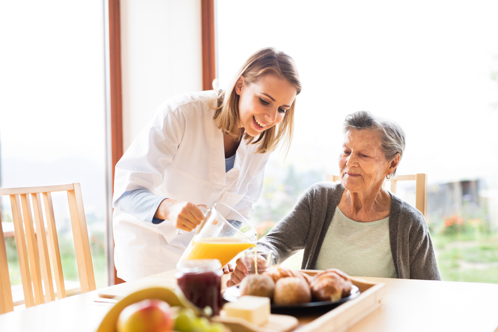 A senior woman at assisted living oceanside receiving help on daily tasks 