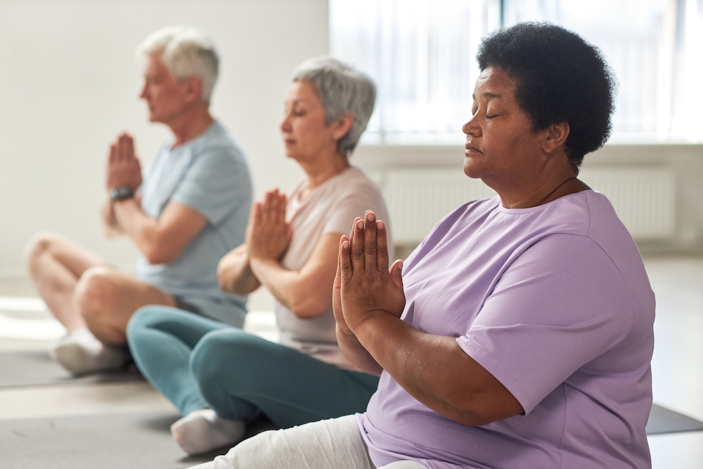 The older adults meditating at the senior living in Oceanside