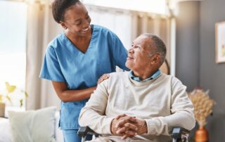A senior man receives assistance from a nurse as a part of memory care services