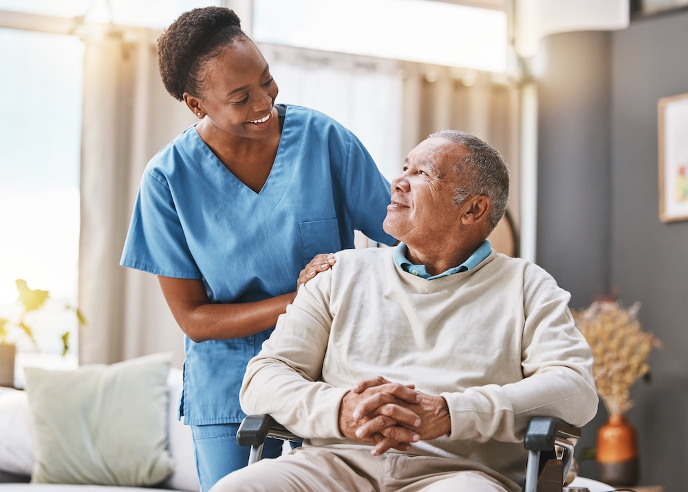 A senior man receives assistance from a nurse as a part of memory care services