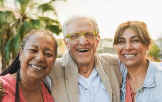 Senior man with two women outside enjoying Carlsbad Senior Living Communities