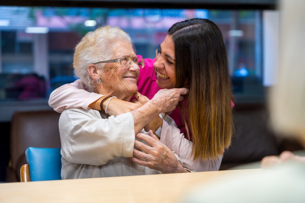 Senior woman with caregiver after finding the best memory care facilities near me